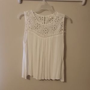 A beautiful white summer blouse with lace yolk button in the back